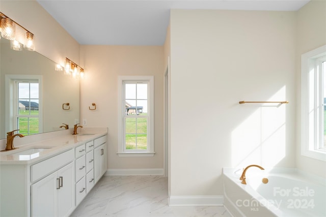 bathroom featuring a tub to relax in and vanity