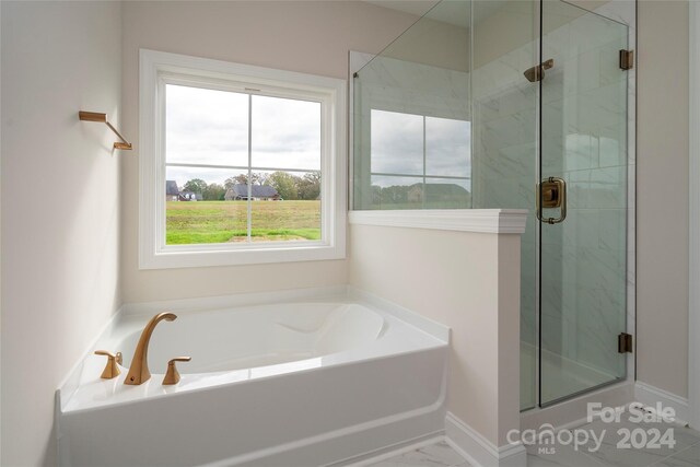 bathroom with separate shower and tub