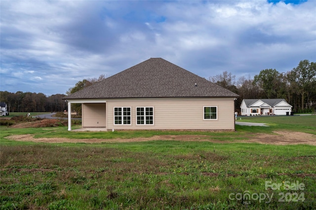 rear view of property featuring a patio area and a yard