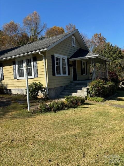 view of front of home featuring a front yard and a porch