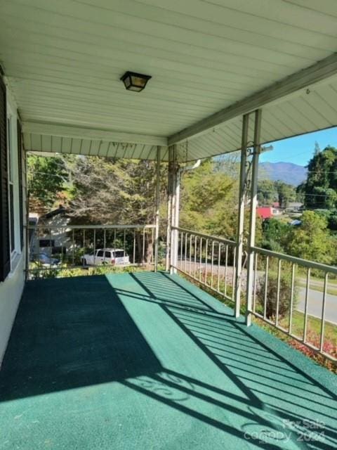 view of patio / terrace with a mountain view and a balcony