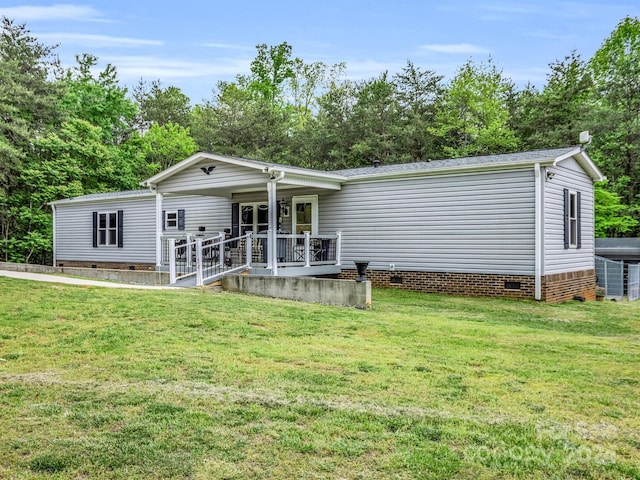 rear view of house with central air condition unit and a lawn