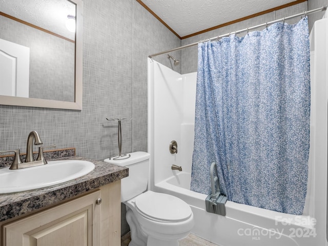 full bathroom featuring toilet, vanity, shower / tub combo with curtain, tile walls, and a textured ceiling