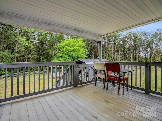 wooden deck featuring a yard