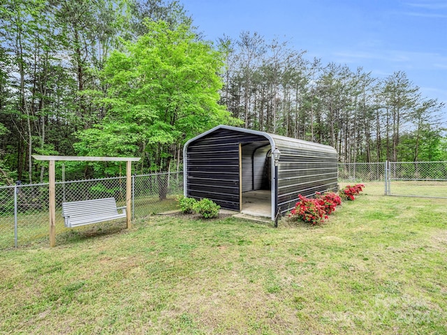 view of outdoor structure featuring a carport and a lawn