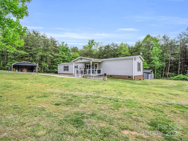 rear view of house with a yard and a carport