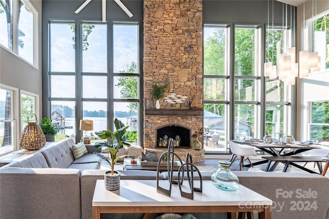 living room featuring a fireplace and a towering ceiling