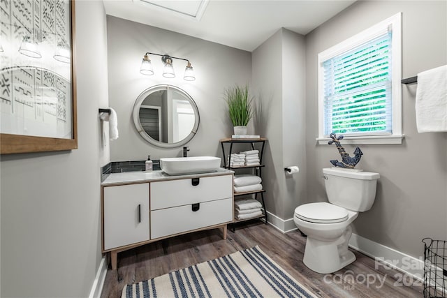 bathroom featuring vanity, toilet, and hardwood / wood-style flooring