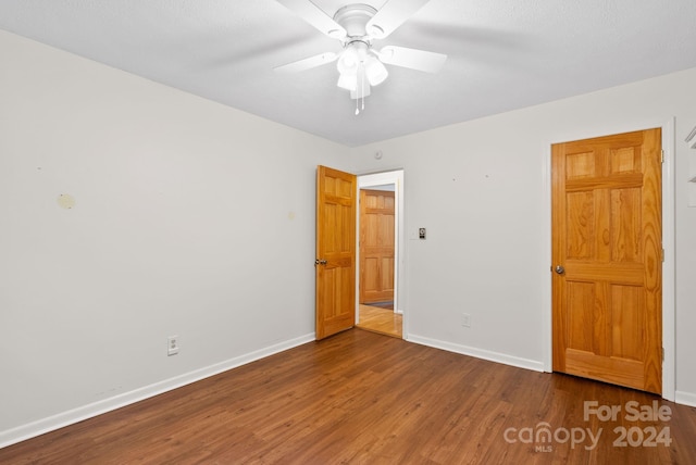 unfurnished room featuring ceiling fan and wood-type flooring