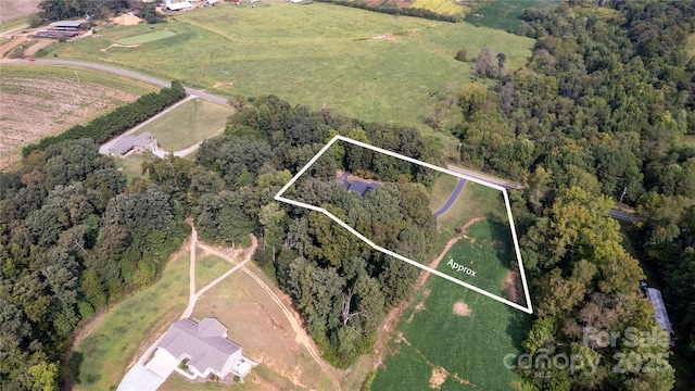 birds eye view of property featuring a rural view