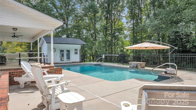 view of pool with a patio area, ceiling fan, and an outdoor structure