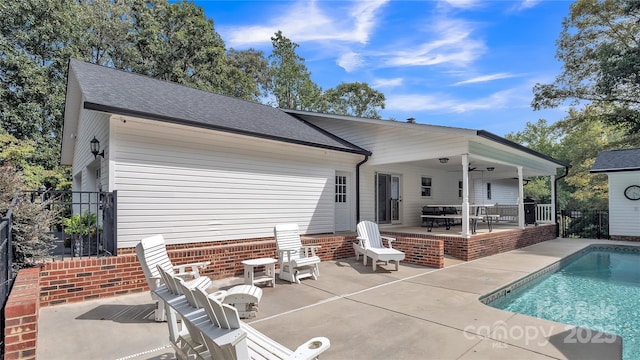 rear view of property featuring a patio area and ceiling fan