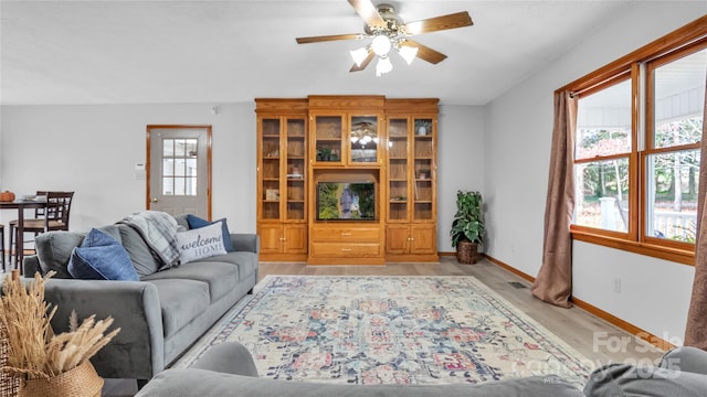 living room featuring ceiling fan and light wood-type flooring