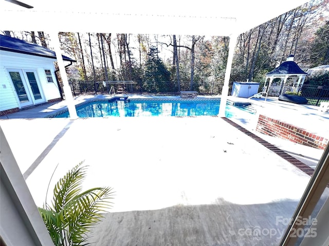 view of swimming pool with a gazebo, a hot tub, and a patio area