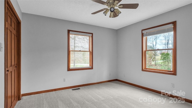 carpeted empty room with ceiling fan