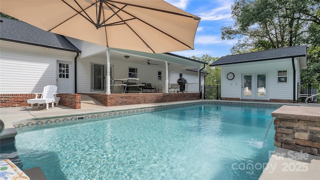 view of pool featuring a patio, area for grilling, and an outdoor structure