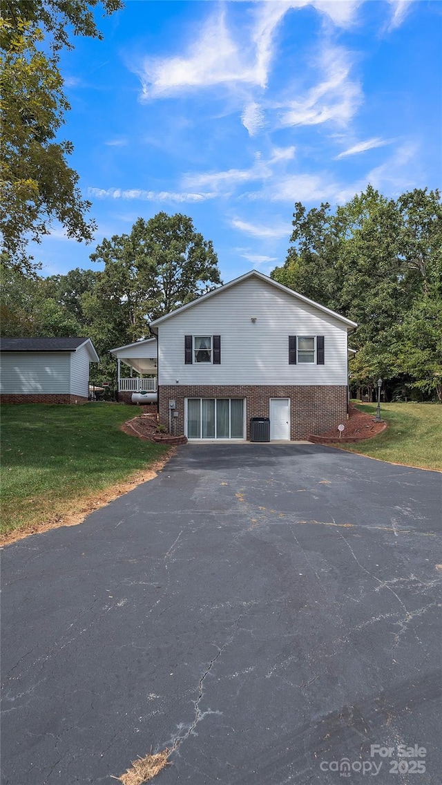 exterior space featuring central AC and a front yard