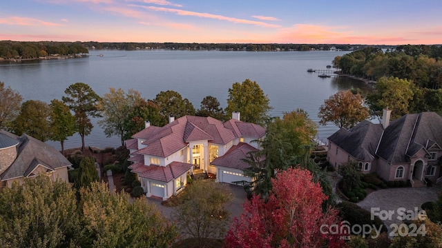 aerial view at dusk with a water view