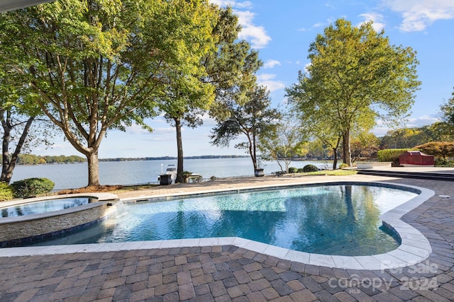 view of pool with a water view, an in ground hot tub, and a patio