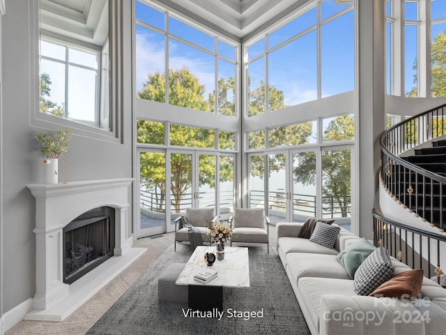 sunroom featuring a water view