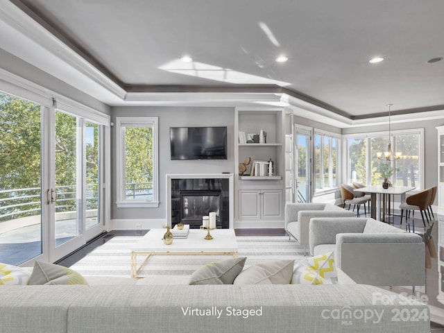 living room with ornamental molding and a notable chandelier