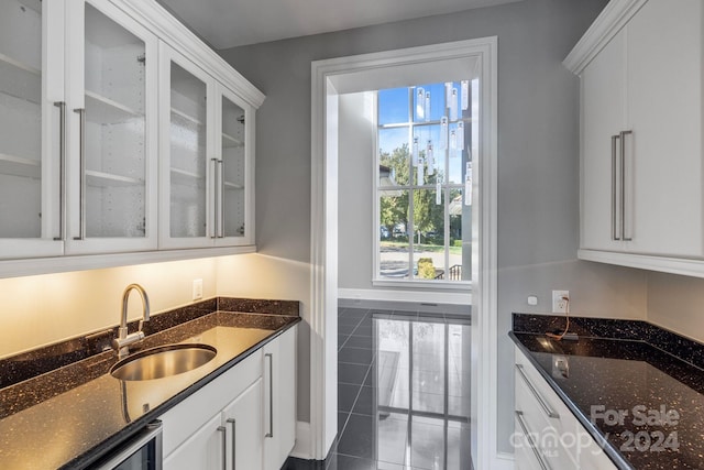 kitchen with white cabinets, sink, and plenty of natural light