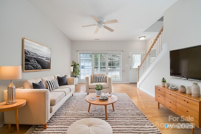 living room with ceiling fan and light wood-type flooring