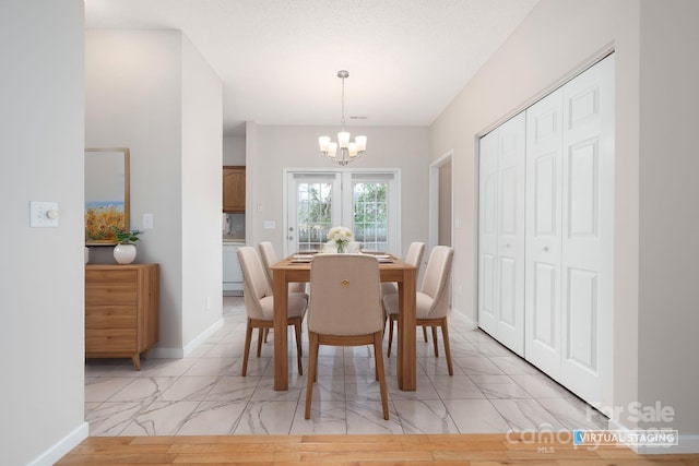 dining space with an inviting chandelier