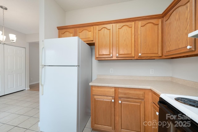 kitchen featuring pendant lighting, light tile patterned floors, a notable chandelier, and white refrigerator