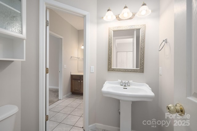 bathroom featuring tile patterned flooring and toilet