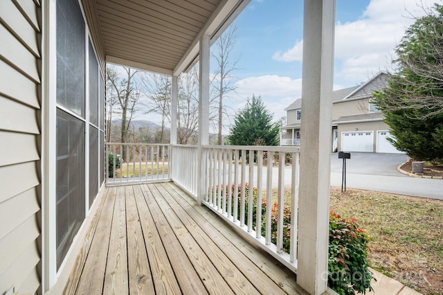 wooden terrace with a garage