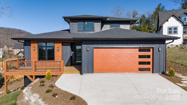 view of front of home featuring a garage and a wooden deck