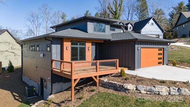 view of front of home with a wooden deck, a garage, and central air condition unit