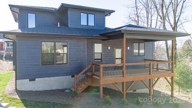 rear view of property with a wooden deck