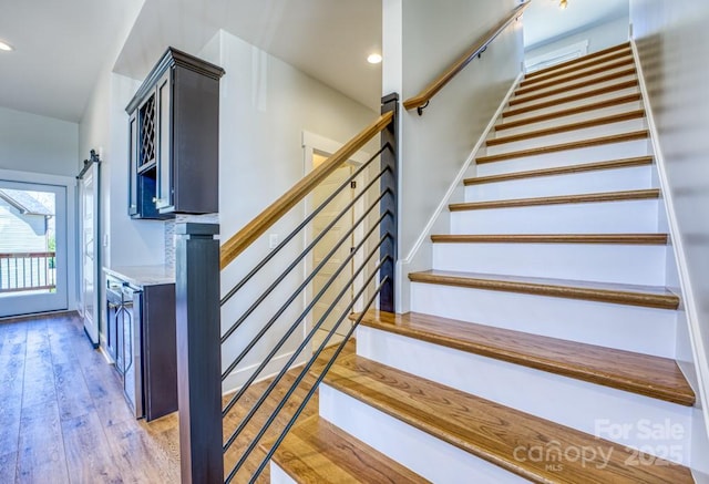 stairway with hardwood / wood-style flooring