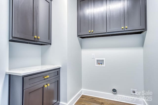 laundry area featuring dark hardwood / wood-style floors, washer hookup, electric dryer hookup, and cabinets