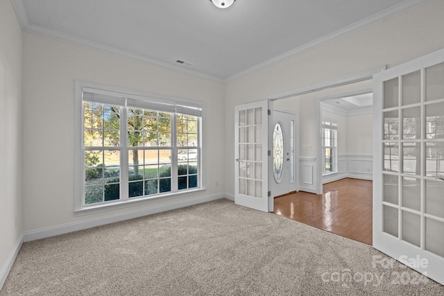 spare room featuring carpet flooring, french doors, and crown molding