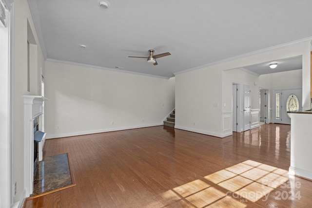 unfurnished living room with hardwood / wood-style floors, ceiling fan, and crown molding