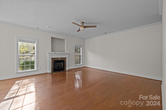 unfurnished living room with a fireplace, ornamental molding, and light wood-type flooring