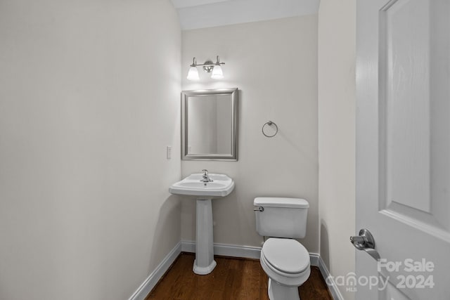 bathroom with wood-type flooring and toilet