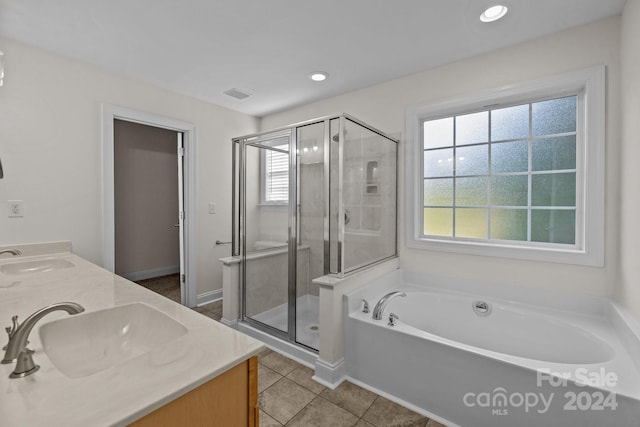 bathroom featuring tile patterned flooring, vanity, and plus walk in shower