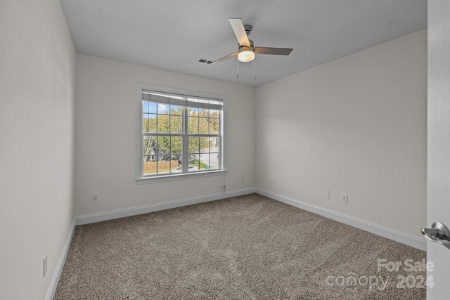 spare room featuring carpet flooring and ceiling fan