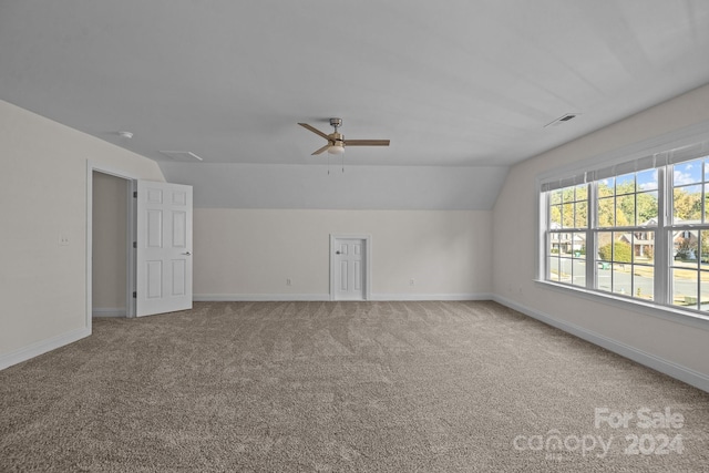 spare room with carpet flooring, ceiling fan, and vaulted ceiling