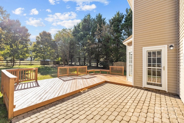 wooden deck featuring a lawn