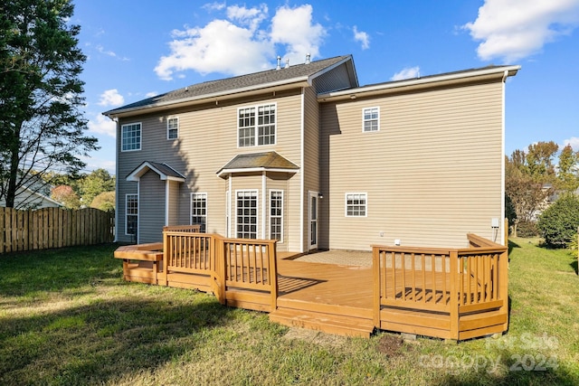 back of house with a lawn and a wooden deck