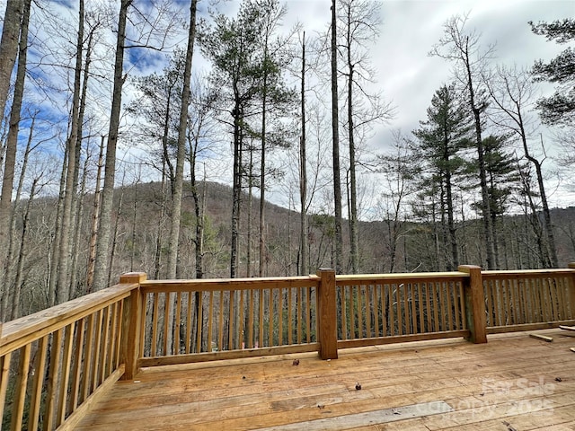 wooden deck featuring a view of trees