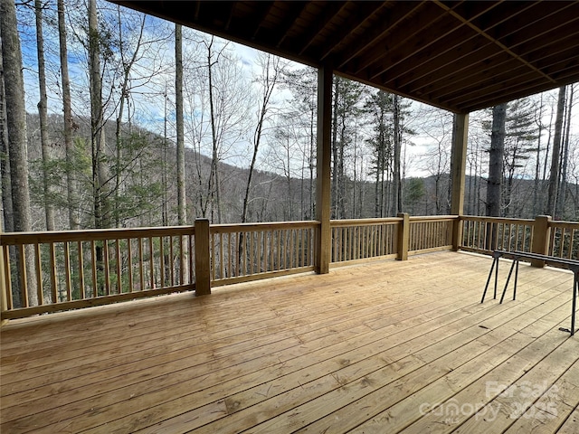 wooden terrace with a wooded view