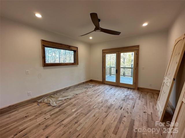 spare room with light wood-style floors, recessed lighting, and french doors