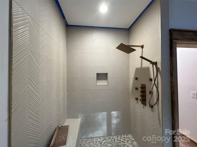 bathroom with tiled shower