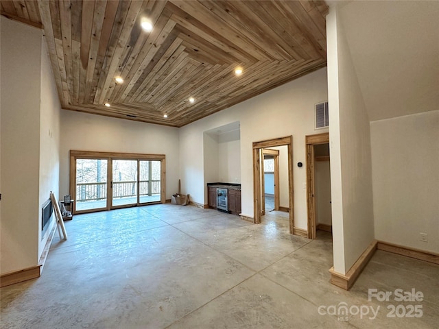 unfurnished living room featuring concrete flooring, visible vents, wood ceiling, and baseboards